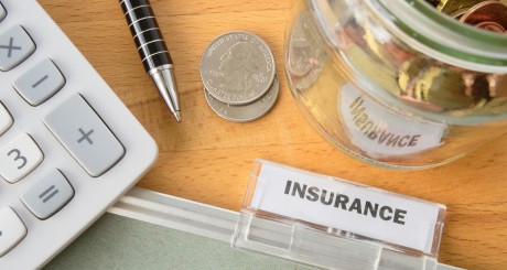 a pen, calculator and insurance policy